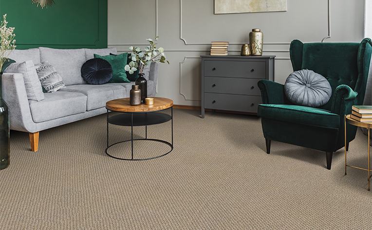 living room with green chair and beige carpet